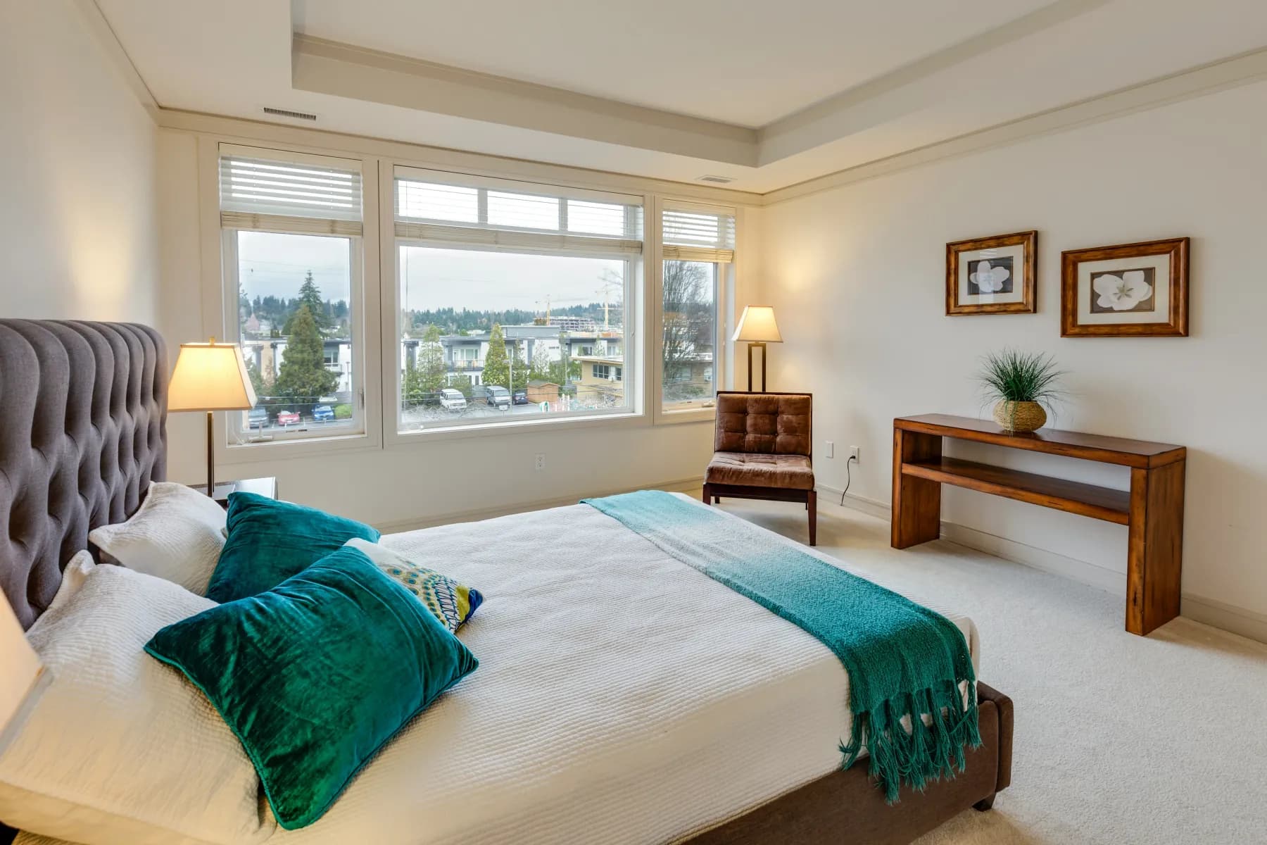 Tidy bedroom with a made bed and a large window