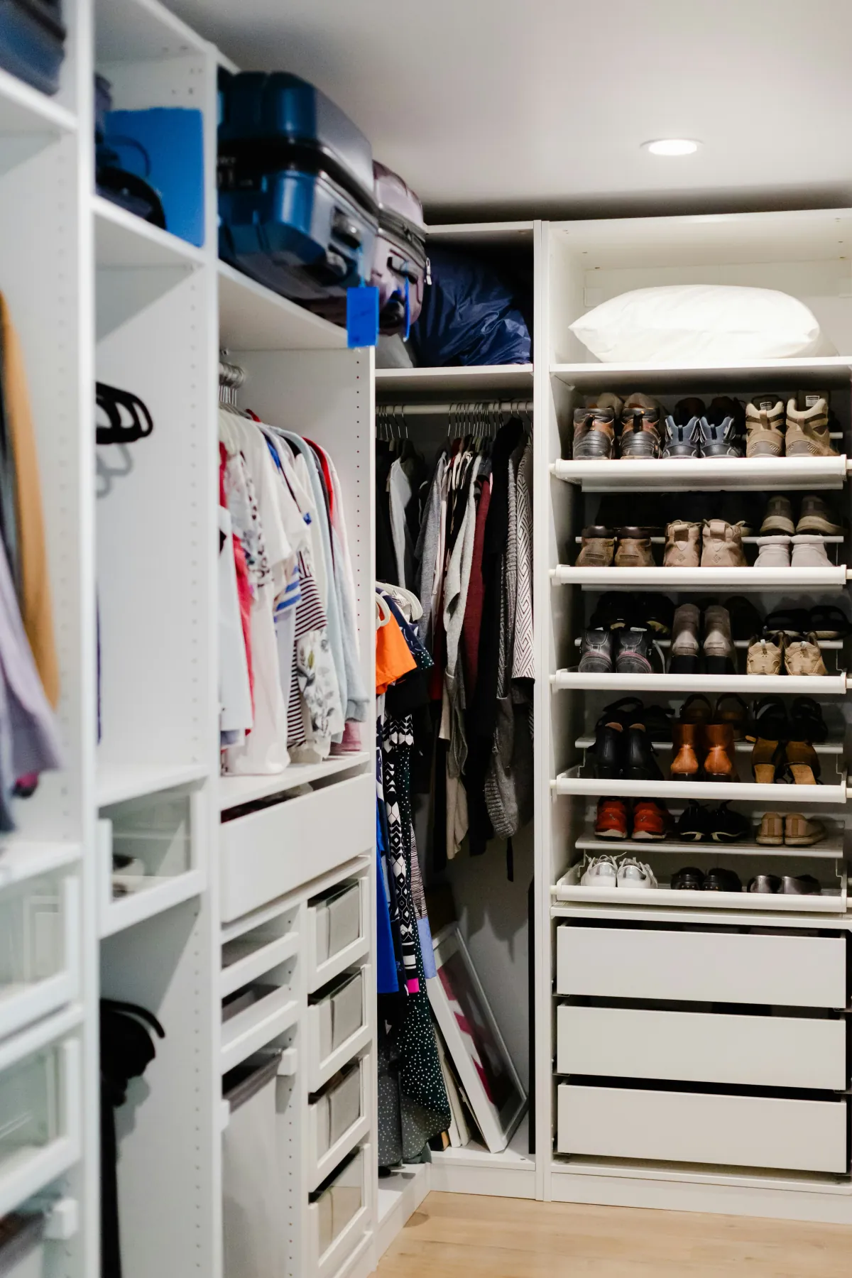 Neatly organized walk-in closet with shoes and clothing