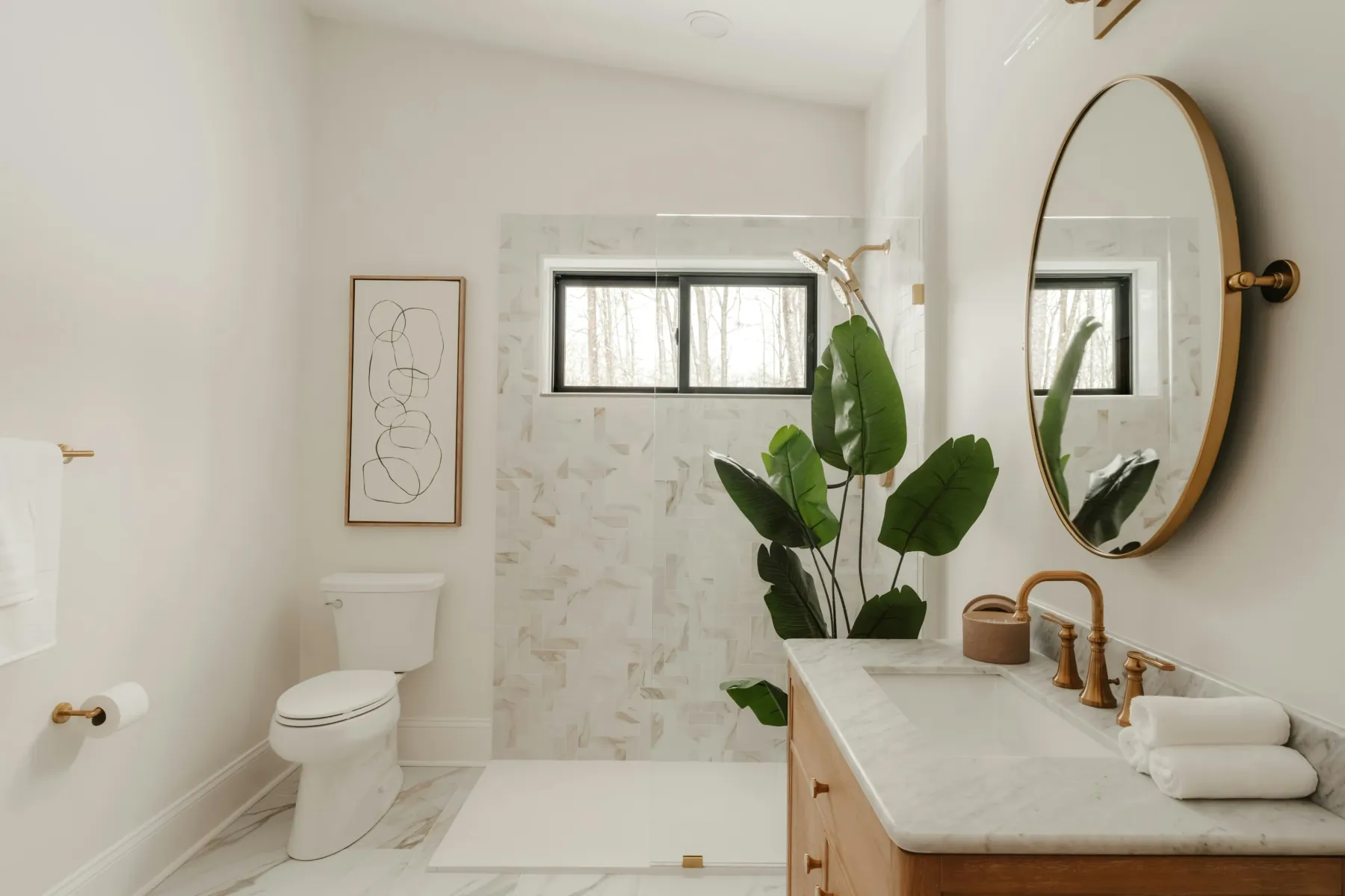 Bright bathroom with marble tile, a walk-in shower and a plant